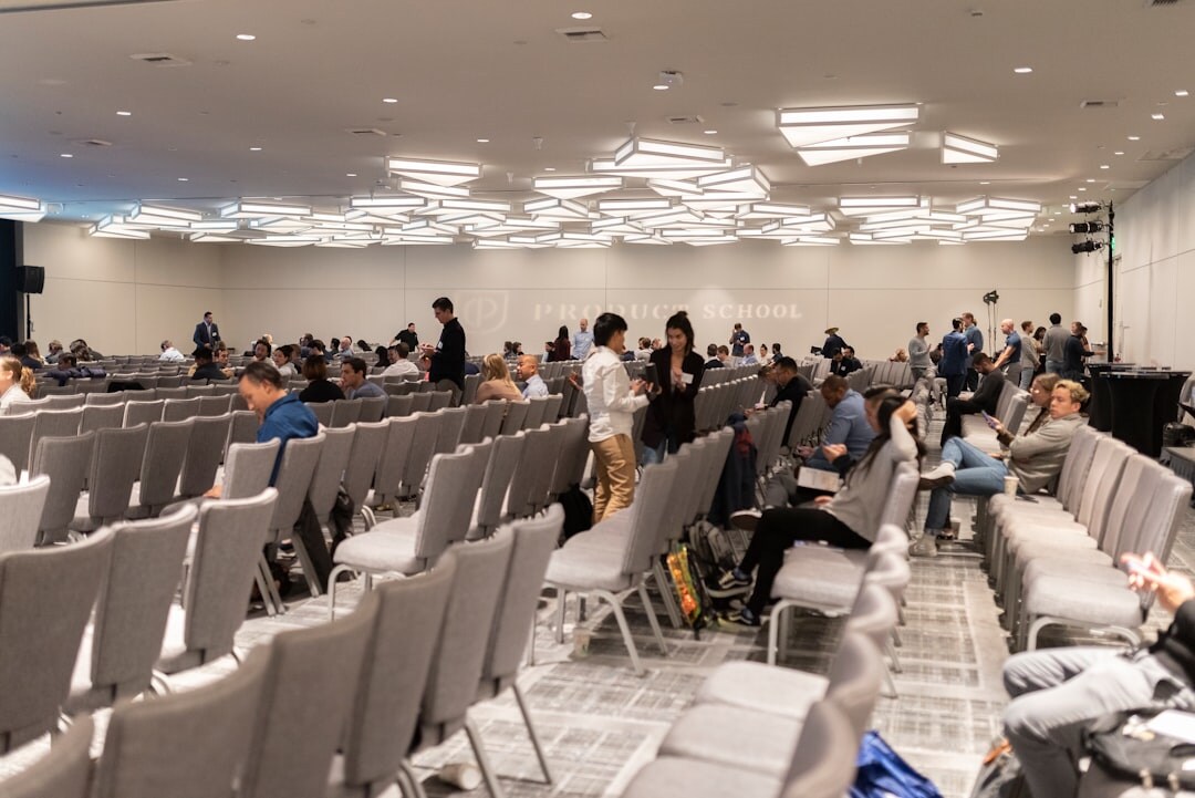 Large professional conference with audience and speakers on stage
